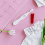 pregnancy test kit on pink background