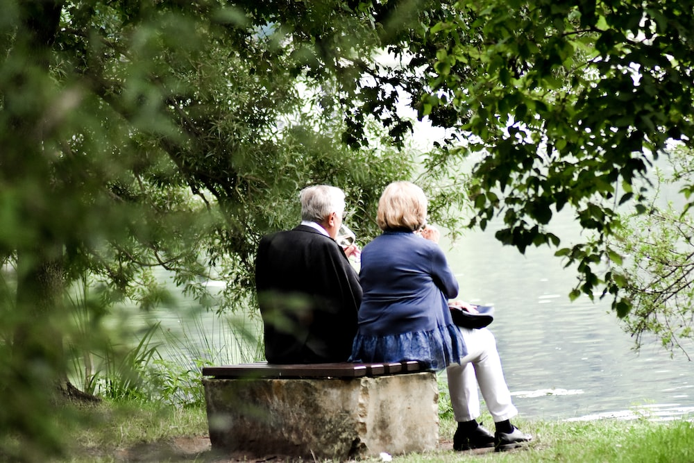 senior citizens sitting on a bench