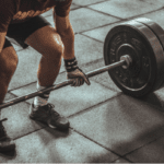 A man is lifting a barbell.