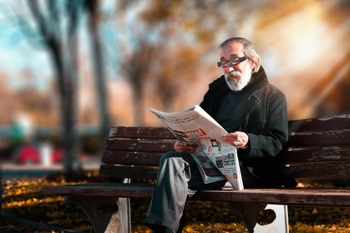 A man is reading a newspaper