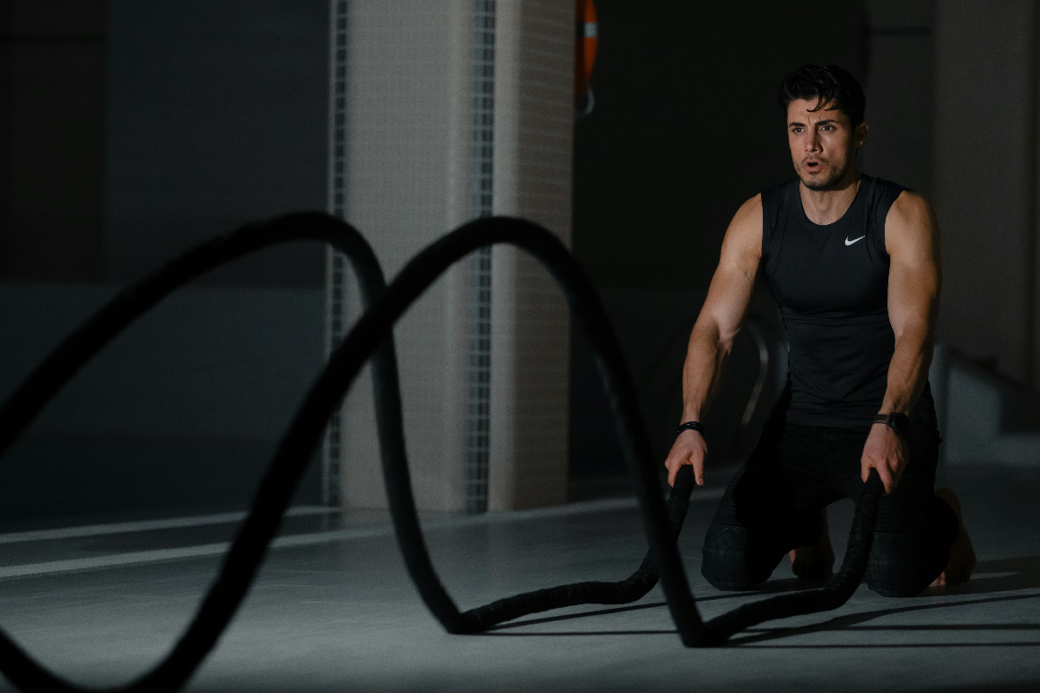 A person exercising with ropes.